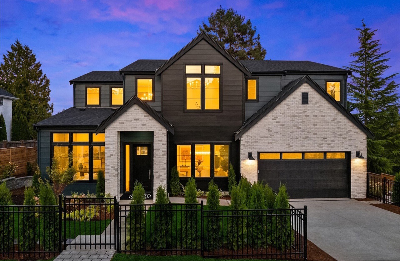 A home at dusk, lights on